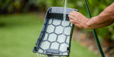 Dolphin Skimmi 300 filter tray being rinsed clean with a garden hose
